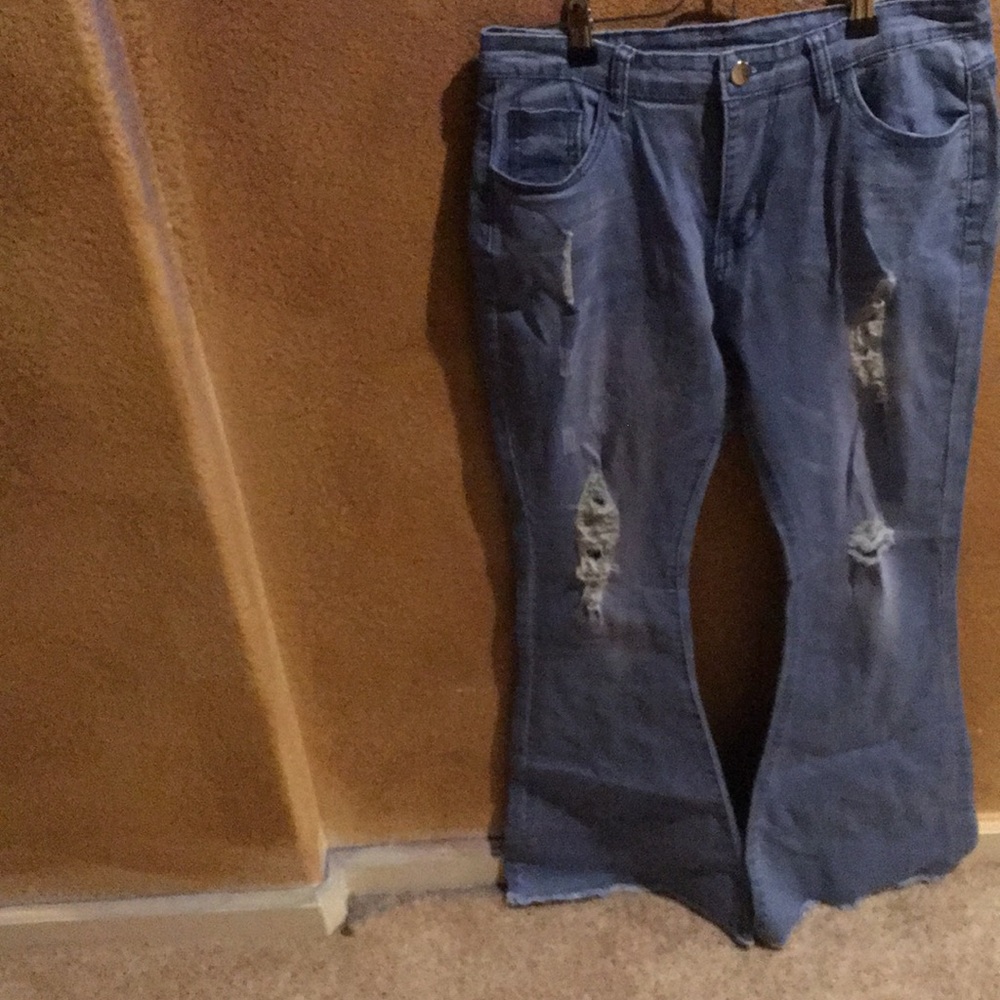 Ripped bell bottom denim jeans.